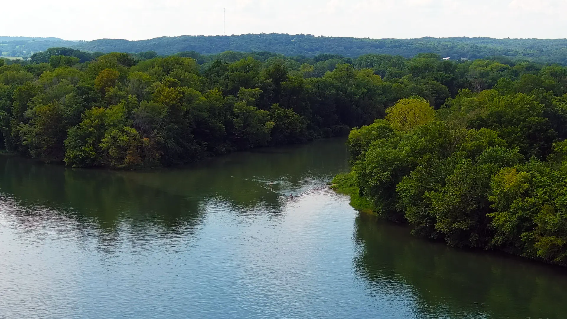 An aerial view of a kayaker paddling where Polk Bayou flows into the White River.